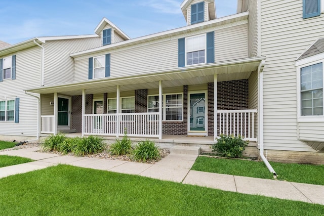 276 NW Georgetown Blvd, Ankeny, IA 50023 - townhome / multi-family property featuring covered porch and brick siding