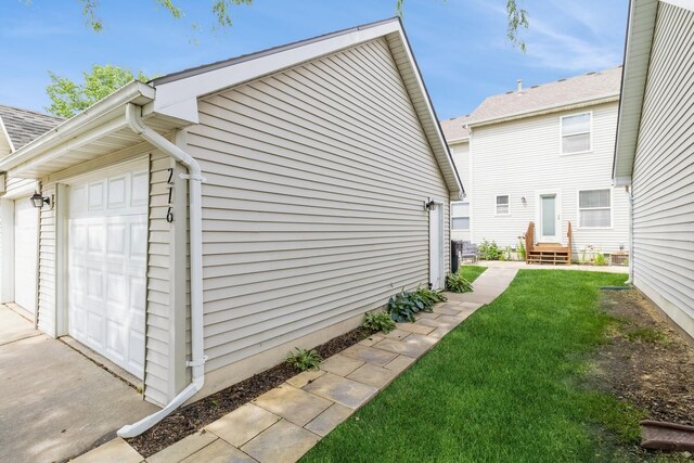 276 NW Georgetown Blvd, Ankeny, IA 50023 - view of property exterior with a yard, a garage, and entry steps