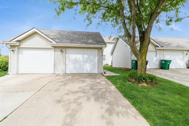 276 NW Georgetown Blvd, Ankeny, IA 50023 - view of front of property with a front lawn, a garage, a shingled roof, and an outbuilding