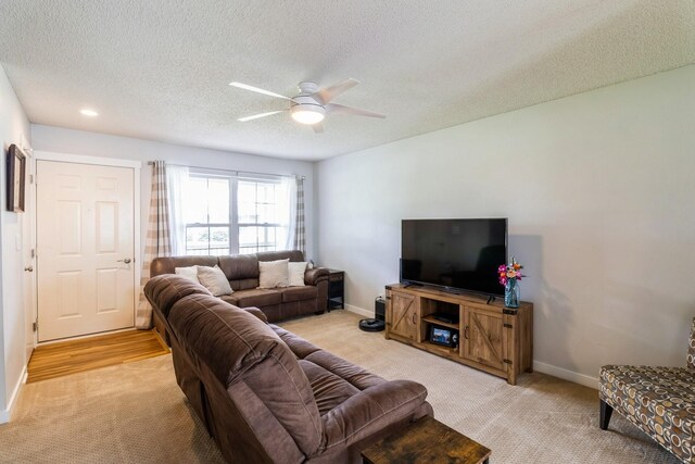 276 NW Georgetown Blvd, Ankeny, IA 50023 - living area featuring light carpet, a ceiling fan, and a textured ceiling