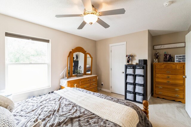276 NW Georgetown Blvd, Ankeny, IA 50023 - bedroom featuring light colored carpet, ceiling fan, and a textured ceiling
