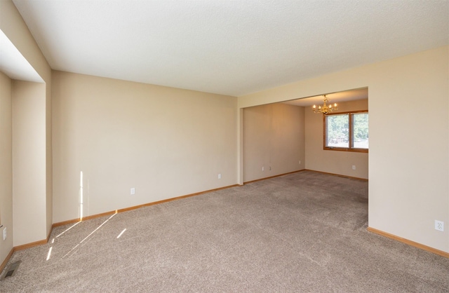 7523 Aspen Dr, West Des Moines, IA 50266 - unfurnished room featuring carpet and a chandelier