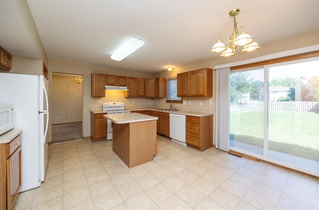 7523 Aspen Dr, West Des Moines, IA 50266 - kitchen with white appliances, a chandelier, light countertops, and under cabinet range hood