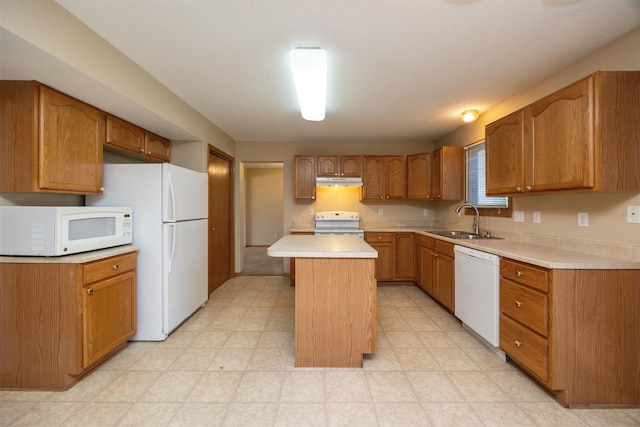 7523 Aspen Dr, West Des Moines, IA 50266 - kitchen featuring white appliances, a kitchen island, under cabinet range hood, light countertops, and brown cabinets