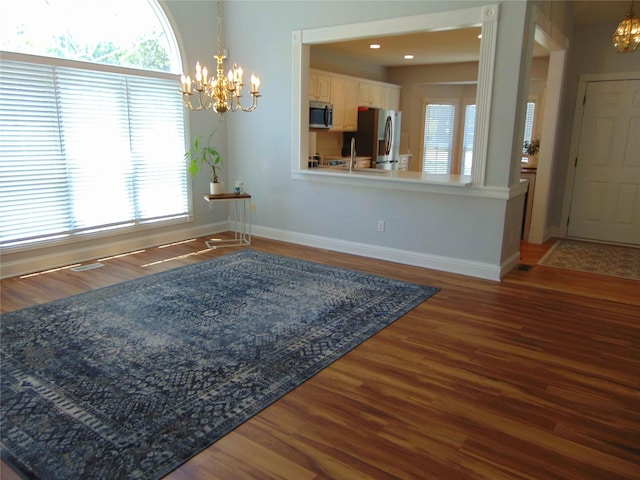 8114 Cobblestone Ct, Urbandale, IA 50322 - unfurnished dining area featuring a chandelier and wood finished floors
