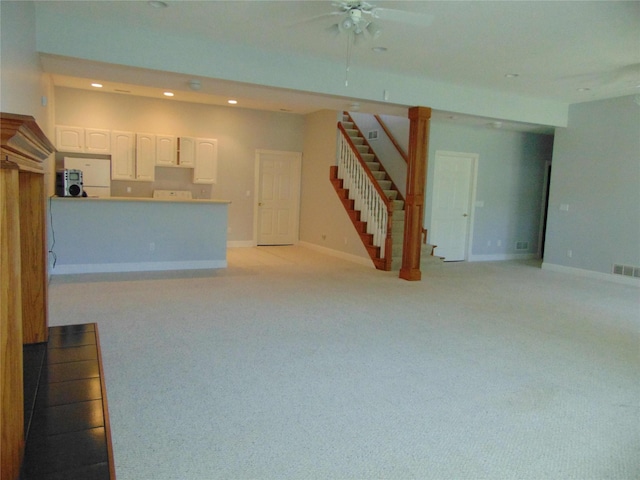 8114 Cobblestone Ct, Urbandale, IA 50322 - unfurnished living room with stairs, recessed lighting, light colored carpet, and a ceiling fan