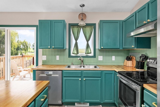2207 Vista View Dr, Granger, IA 50109 - kitchen featuring appliances with stainless steel finishes, under cabinet range hood, wooden counters, and hanging light fixtures
