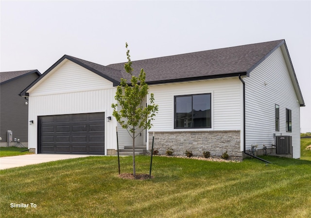 605 NW Compass Ave, Waukee, IA 50263 - view of front of property featuring an attached garage, concrete driveway, a front lawn, and roof with shingles