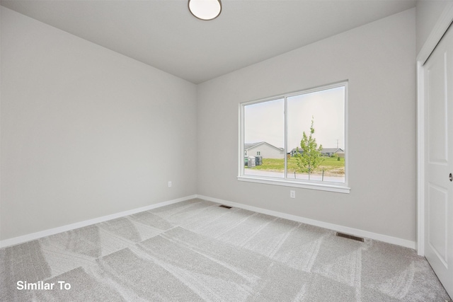 1163 NW Petersen Dr, Waukee, IA 50263 - spare room featuring light colored carpet and baseboards