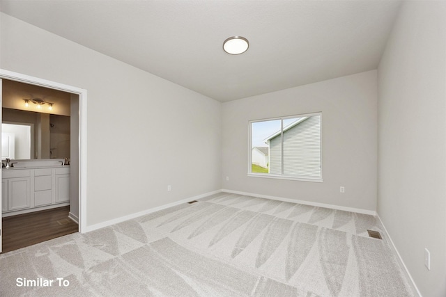 1163 NW Petersen Dr, Waukee, IA 50263 - unfurnished bedroom featuring light colored carpet and connected bathroom
