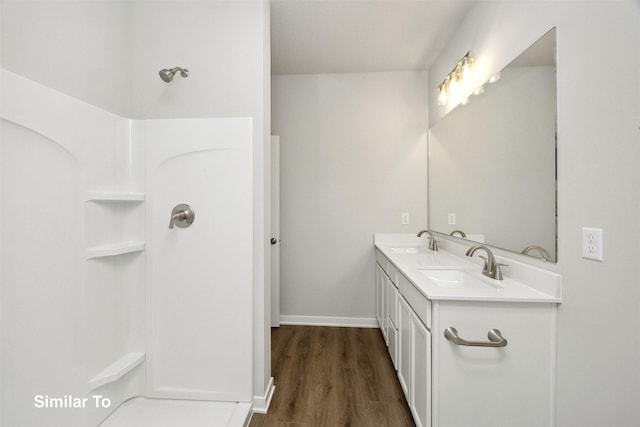 1163 NW Petersen Dr, Waukee, IA 50263 - bathroom with double vanity, wood finished floors, and a shower