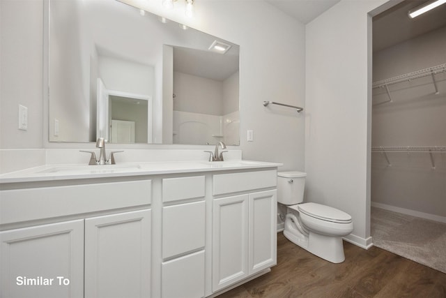 1163 NW Petersen Dr, Waukee, IA 50263 - bathroom with double vanity, wood finished floors, a shower, and a spacious closet