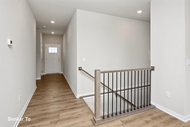1163 NW Petersen Dr, Waukee, IA 50263 - corridor featuring an upstairs landing, wood finished floors, and recessed lighting