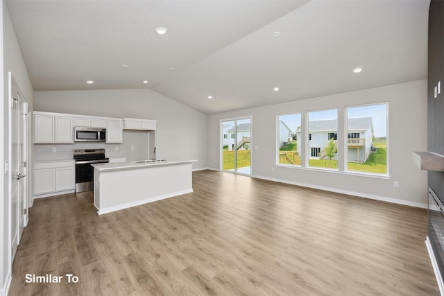 1163 NW Petersen Dr, Waukee, IA 50263 - unfurnished living room featuring vaulted ceiling, light wood-style flooring, and recessed lighting