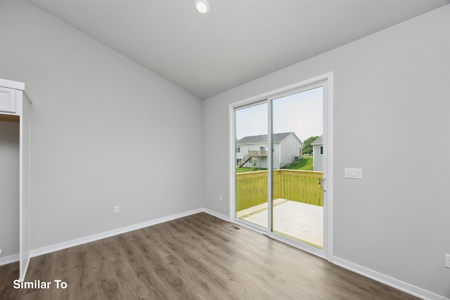 1163 NW Petersen Dr, Waukee, IA 50263 - empty room featuring dark wood-style flooring and lofted ceiling