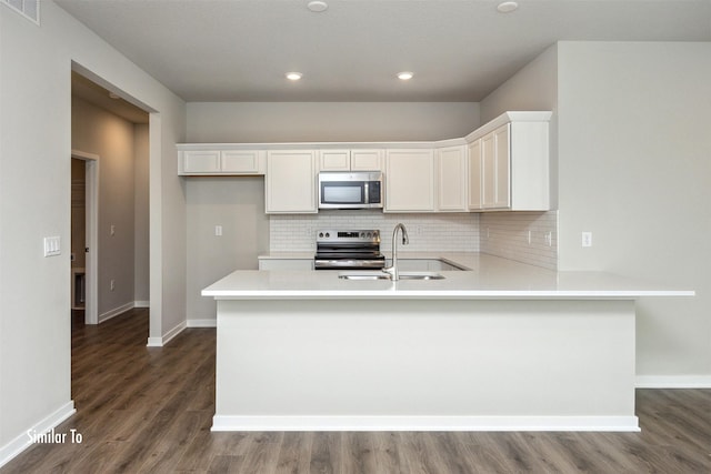 9756 Regatta Ln, Johnston, IA 50131 - kitchen featuring stainless steel appliances, decorative backsplash, dark wood-type flooring, white cabinets, and recessed lighting