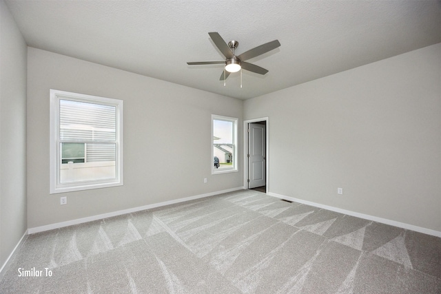 9764 Regatta Ln, Johnston, IA 50131 - carpeted empty room featuring a ceiling fan and baseboards