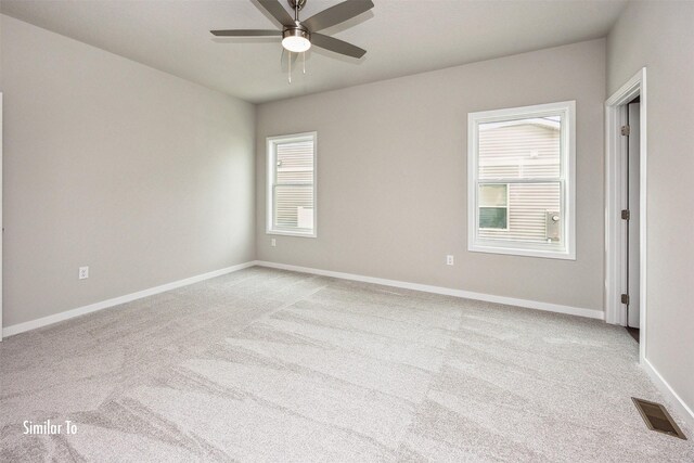 9764 Regatta Ln, Johnston, IA 50131 - unfurnished room with healthy amount of natural light, carpet, and a ceiling fan