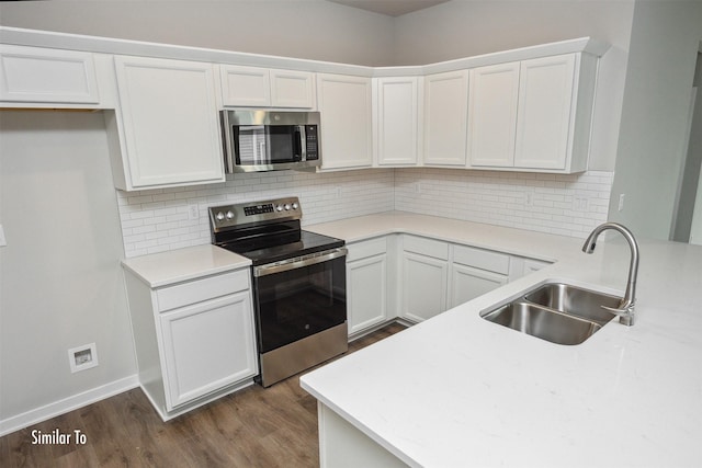 9764 Regatta Ln, Johnston, IA 50131 - kitchen with appliances with stainless steel finishes, dark wood-style floors, white cabinetry, light countertops, and backsplash