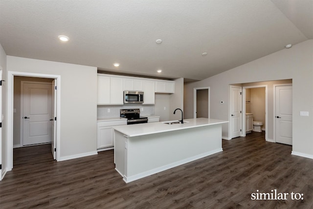 9383 Modena Ln, West Des Moines, IA 50266 - kitchen featuring appliances with stainless steel finishes, white cabinets, dark wood-type flooring, lofted ceiling, and recessed lighting