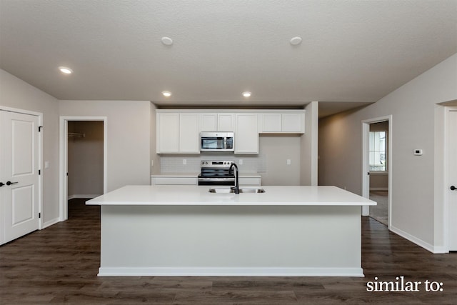 9383 Modena Ln, West Des Moines, IA 50266 - kitchen with appliances with stainless steel finishes, white cabinets, an island with sink, tasteful backsplash, and recessed lighting