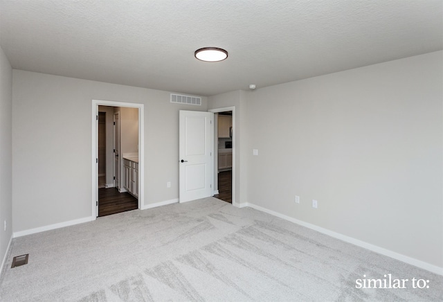 9383 Modena Ln, West Des Moines, IA 50266 - unfurnished bedroom with carpet, a textured ceiling, and ensuite bath