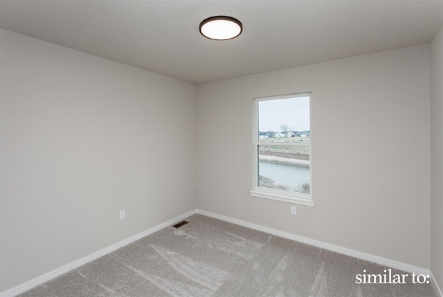 9383 Modena Ln, West Des Moines, IA 50266 - spare room featuring baseboards and carpet flooring