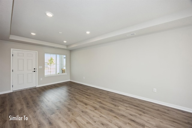 715 Linden St, Carlisle, IA 50047 - empty room featuring a raised ceiling, wood finished floors, and recessed lighting