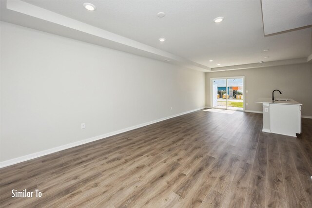 715 Linden St, Carlisle, IA 50047 - unfurnished living room with wood finished floors and recessed lighting