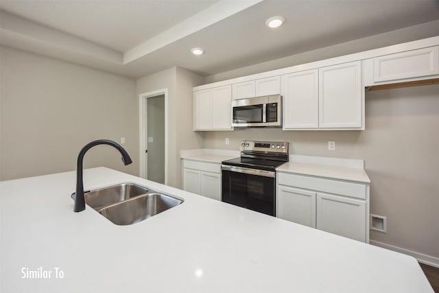 715 Linden St, Carlisle, IA 50047 - kitchen with appliances with stainless steel finishes, recessed lighting, light countertops, and white cabinetry