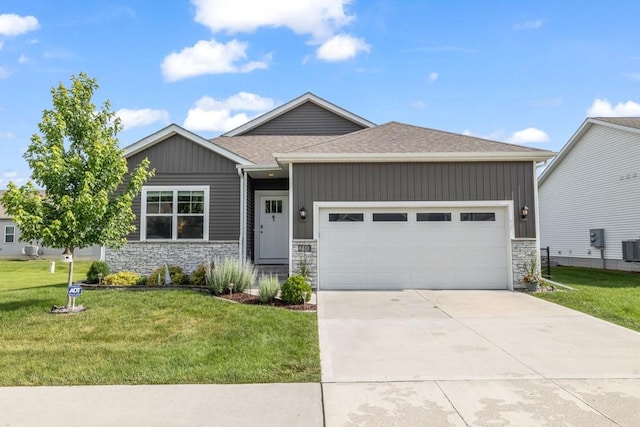 210 SE Willow Run Ln, Ankeny, IA 50021 - view of front facade featuring stone siding, an attached garage, a front lawn, concrete driveway, and a shingled roof