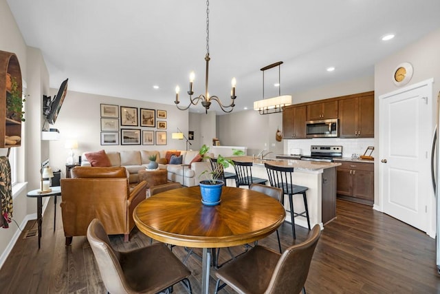 210 SE Willow Run Ln, Ankeny, IA 50021 - dining space with dark wood-style flooring, recessed lighting, and a chandelier