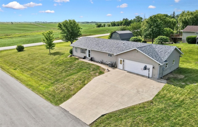 602 8th St, Malcom, IA 50157 - view of front of property with concrete driveway, a front yard, roof with shingles, an attached garage, and a rural view