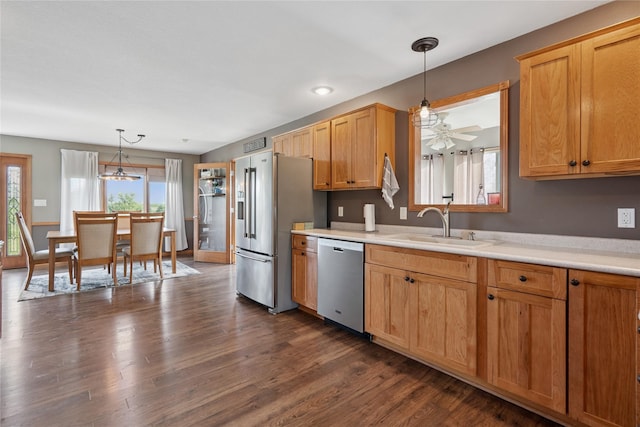 602 8th St, Malcom, IA 50157 - kitchen featuring appliances with stainless steel finishes, light countertops, pendant lighting, dark wood-style floors, and a ceiling fan