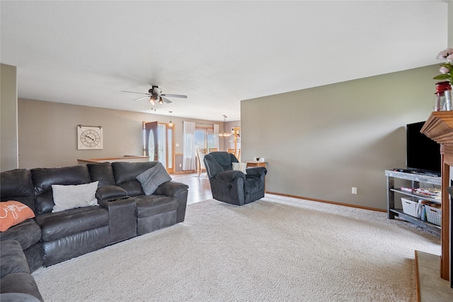 602 8th St, Malcom, IA 50157 - carpeted living room featuring a ceiling fan and a chandelier