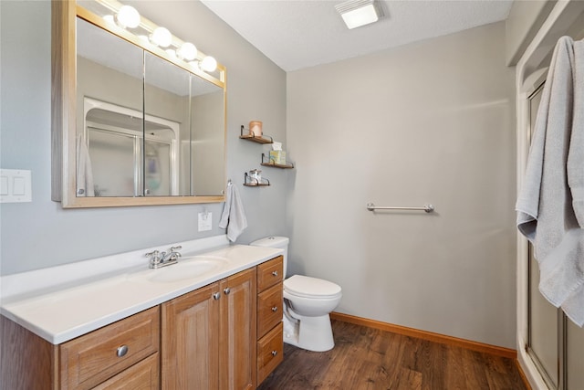 602 8th St, Malcom, IA 50157 - bathroom featuring vanity, a shower stall, and wood finished floors