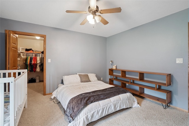 602 8th St, Malcom, IA 50157 - carpeted bedroom featuring a walk in closet, a closet, and ceiling fan