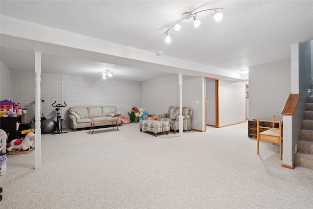 602 8th St, Malcom, IA 50157 - carpeted living room featuring stairway and a textured ceiling