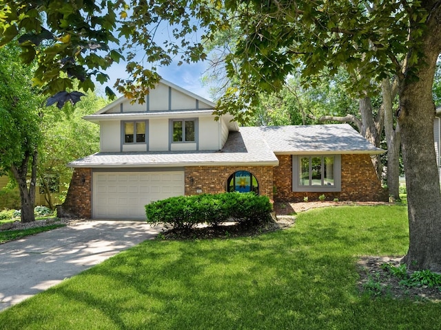 904 52nd St, West Des Moines, IA 50265 - view of front of house featuring a garage, driveway, a front lawn, and brick siding