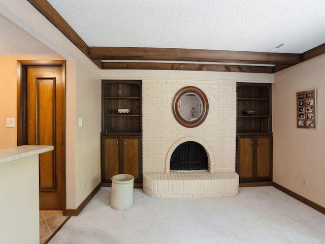 904 52nd St, West Des Moines, IA 50265 - unfurnished living room with a textured ceiling, beamed ceiling, carpet floors, a fireplace, and built in features