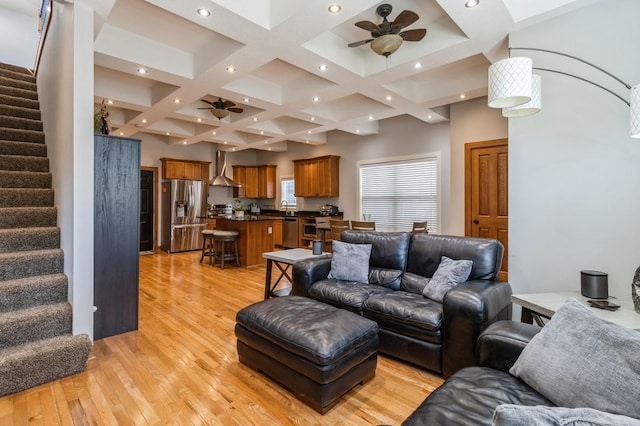 2687 NW 165th Ln, Clive, IA 50325 - living area featuring ceiling fan, stairs, light wood finished floors, coffered ceiling, and beamed ceiling