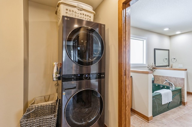 2687 NW 165th Ln, Clive, IA 50325 - laundry area with stacked washer / dryer and tile patterned floors