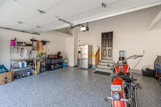 2687 NW 165th Ln, Clive, IA 50325 - garage featuring a garage door opener and stainless steel refrigerator with ice dispenser