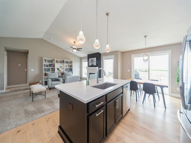 712 Mallard Pointe Dr NW, Bondurant, IA 50035 - kitchen with stainless steel appliances, vaulted ceiling, light countertops, light wood-style flooring, and dark brown cabinetry
