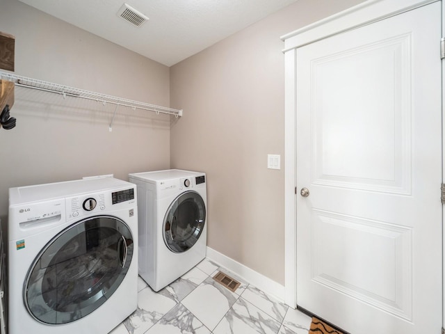 712 Mallard Pointe Dr NW, Bondurant, IA 50035 - laundry area featuring washer and clothes dryer and light marble finish floors