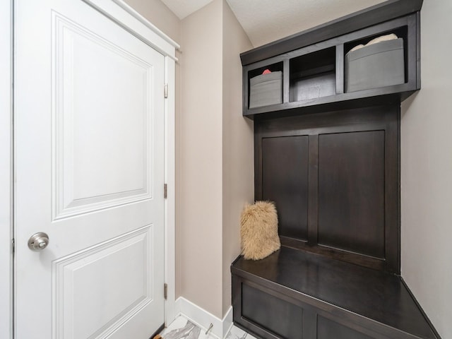 712 Mallard Pointe Dr NW, Bondurant, IA 50035 - mudroom with baseboards and marble look tiles