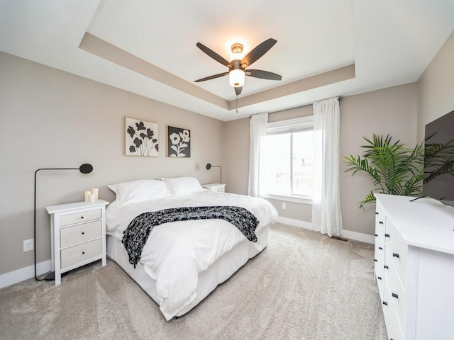 712 Mallard Pointe Dr NW, Bondurant, IA 50035 - bedroom with a raised ceiling, light colored carpet, and a ceiling fan