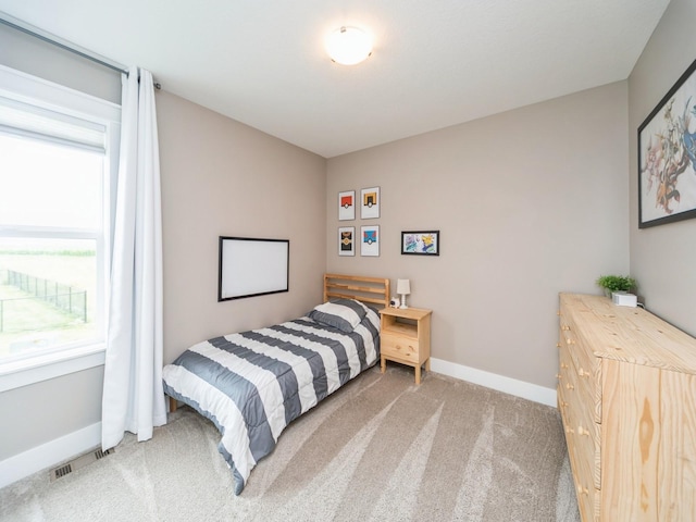 712 Mallard Pointe Dr NW, Bondurant, IA 50035 - bedroom featuring light colored carpet and baseboards