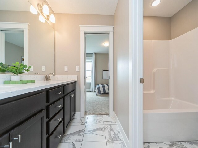 712 Mallard Pointe Dr NW, Bondurant, IA 50035 - ensuite bathroom featuring marble look tile flooring, double vanity, and shower / washtub combination
