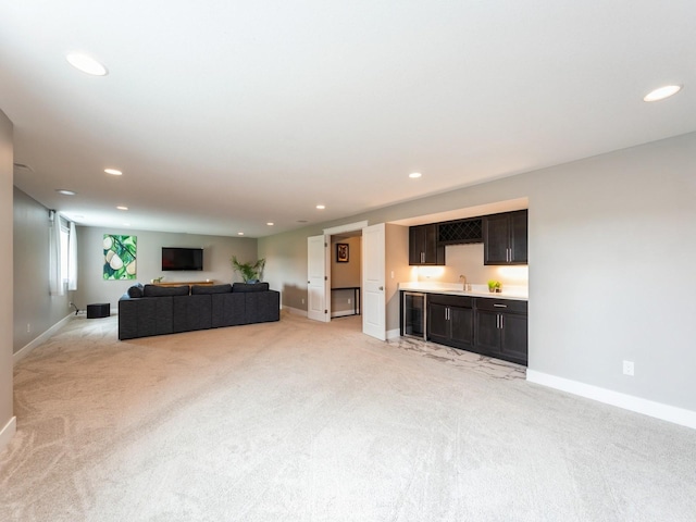 712 Mallard Pointe Dr NW, Bondurant, IA 50035 - living room featuring light colored carpet, recessed lighting, wine cooler, and bar with sink